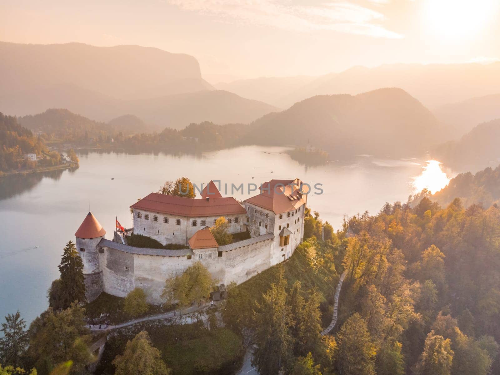 Aerial view of medieval castle by the lake Bled in Slovenia. Beautiful nature of Slovenia in fall.
