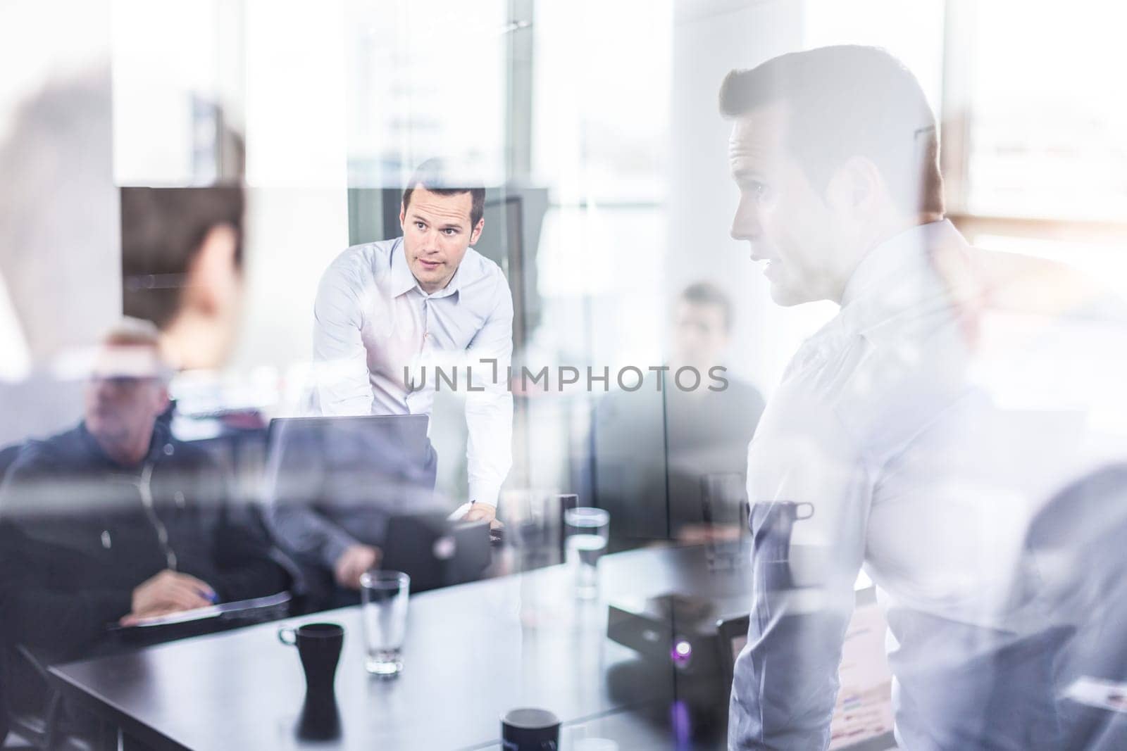Business team brainstorming on meeting in modern corporate office. Business executive delivering presentation to colleagues during meeting or in-house business training. Business and entrepreneurship.
