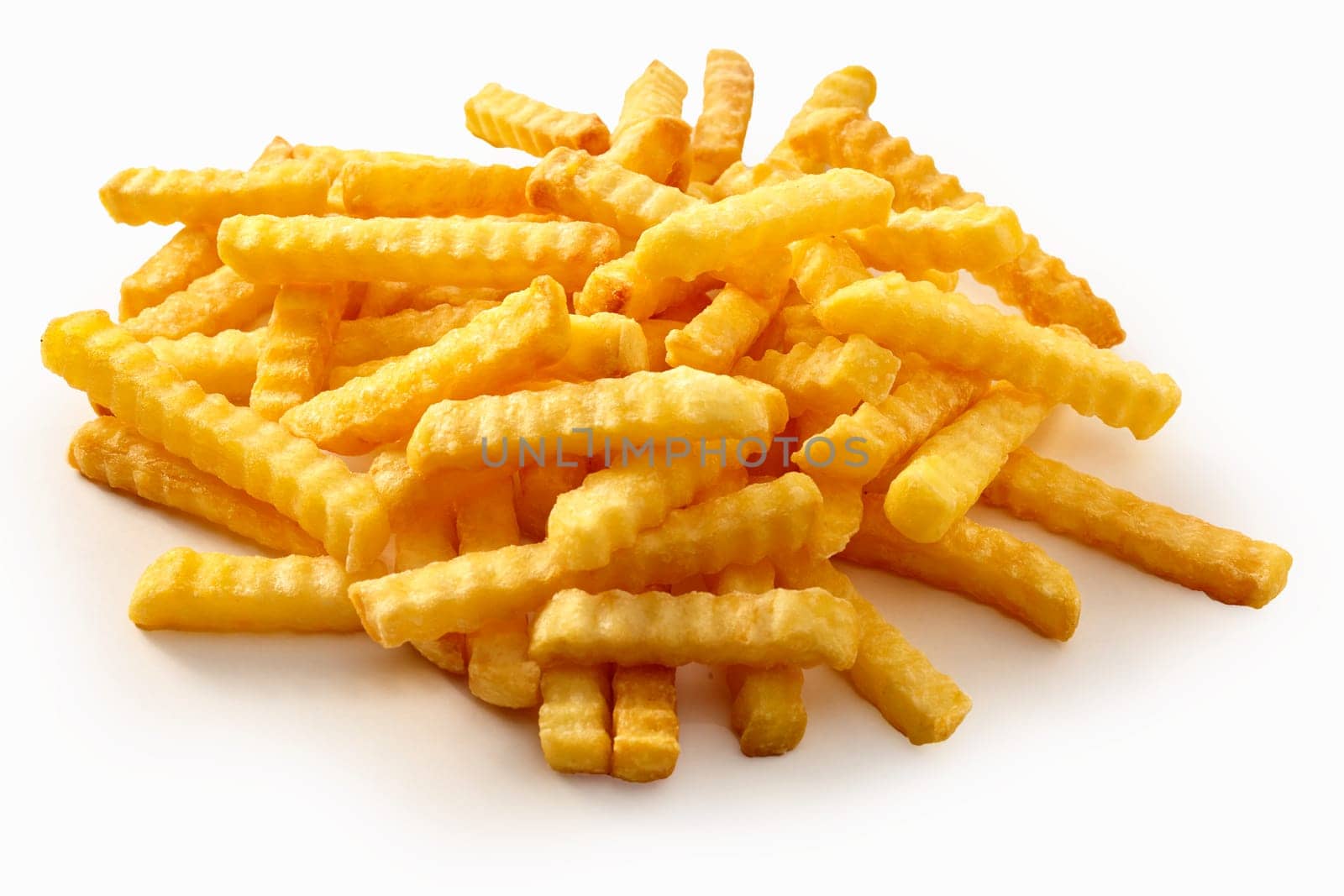 Heap of crispy golden crinkle cut potato chips or Pommes Frites on a white background for a menu