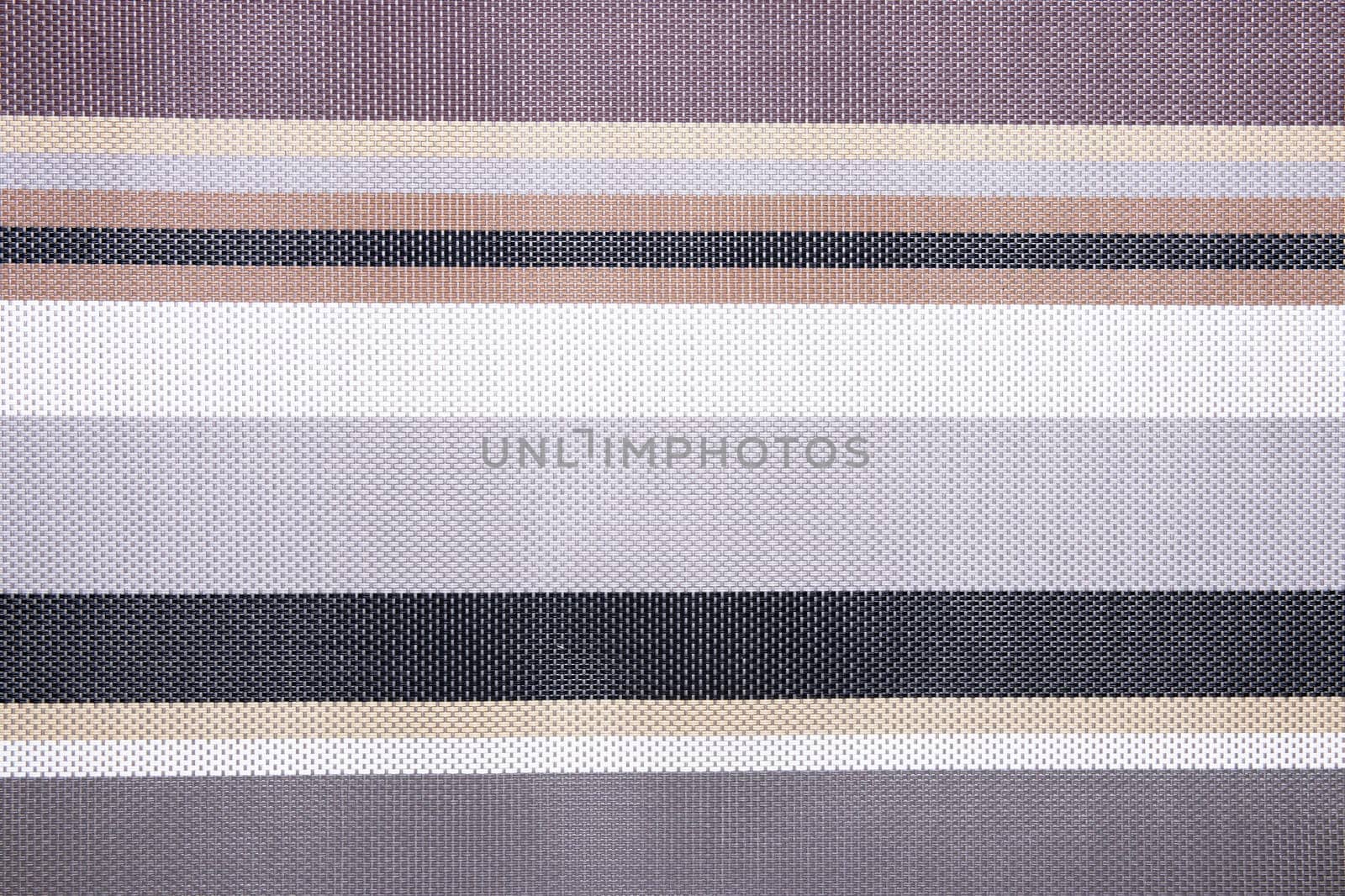 Striped background. Top view of details of colorful horizontal striped background texture with seamless pattern on plastic tissue. Macro.