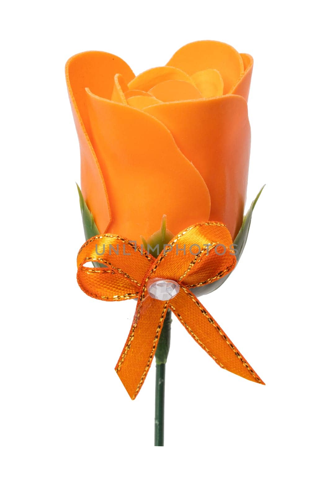 Summer flower background. Closeup of a artificial orange flower with a matching ribbon bow isolated on a white background. Design element for valentine, wedding or other holidays. Macro.