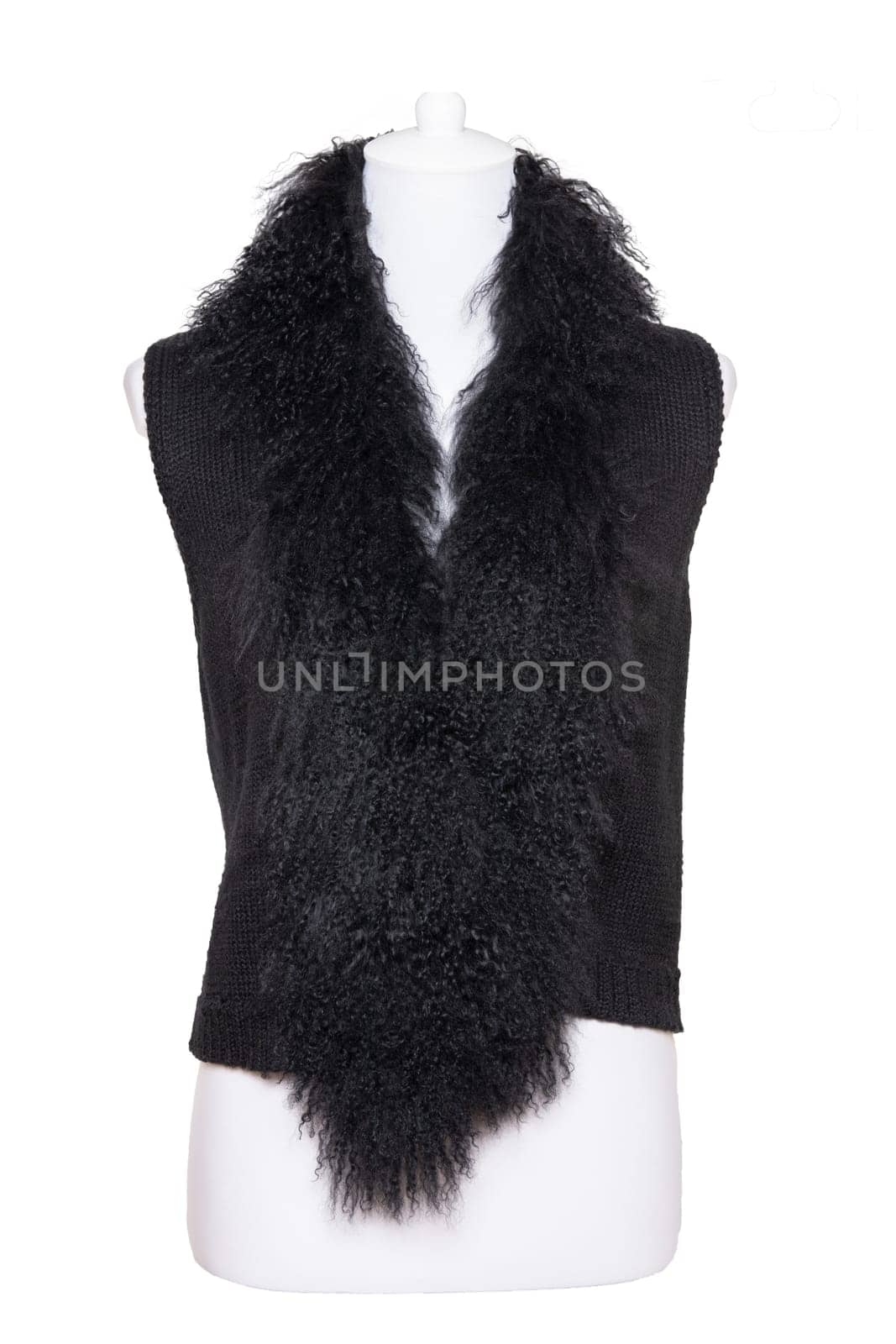 Vest isolated. Black women vest with a large fur collar on mannequin isolated on a white background. Woman fashion.