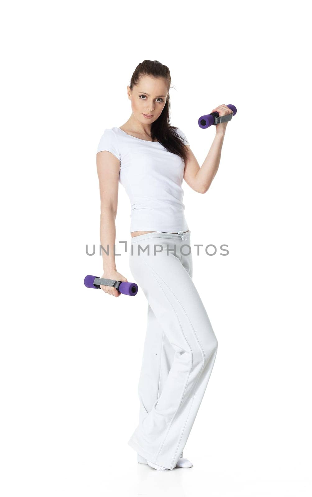 Young sports woman with dumbbells on a white background. Training.
