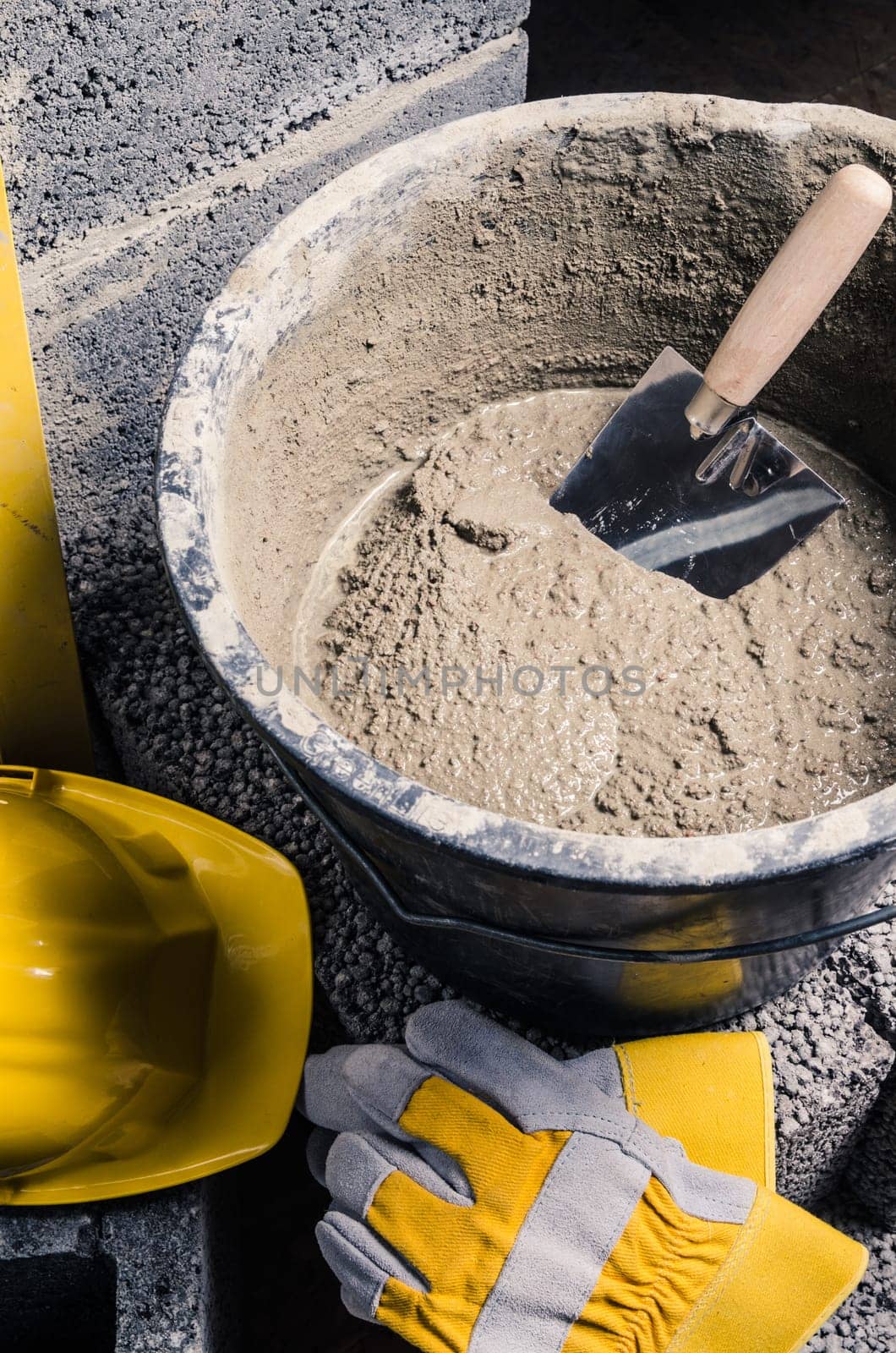 Tools for bricklayer bucket with a solution and a trowel, close-up