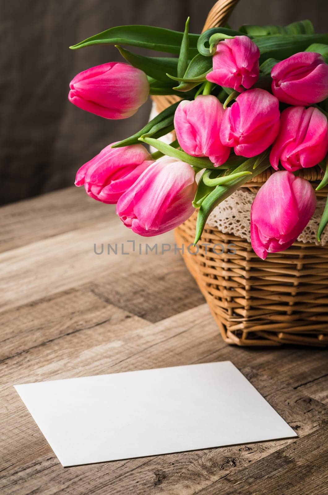 Beautiful bouquet of pink tulips and congratulations on the table