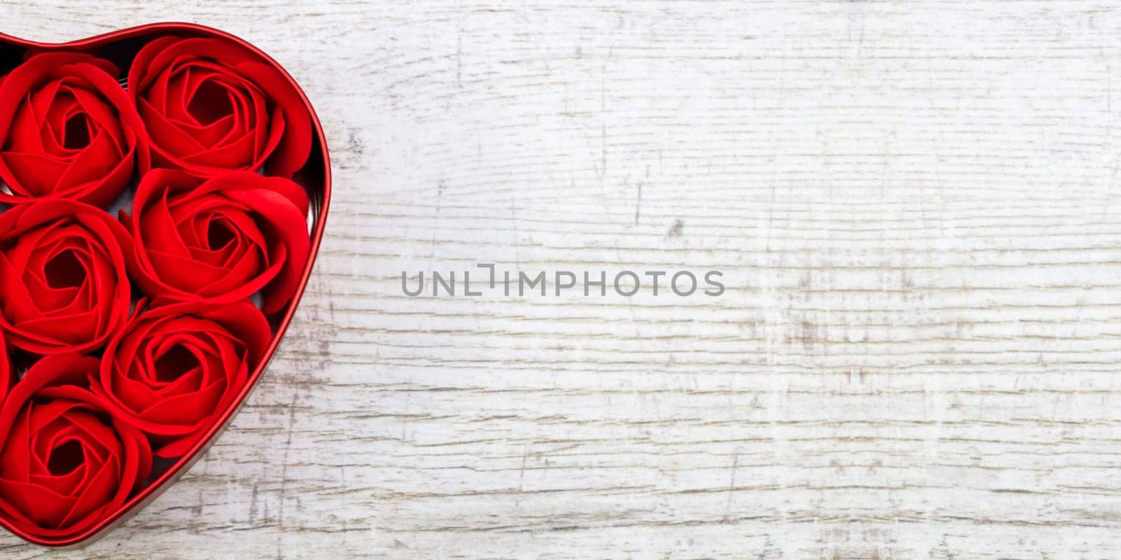 Red roses in a heart-shaped box