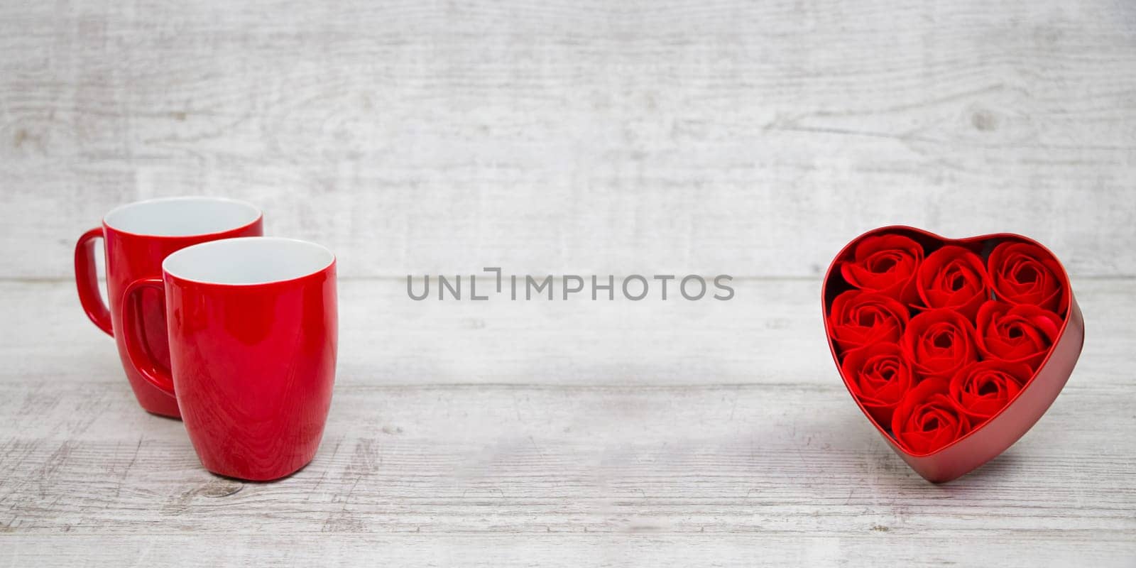 Shiny Red coffee cups and red heart roses