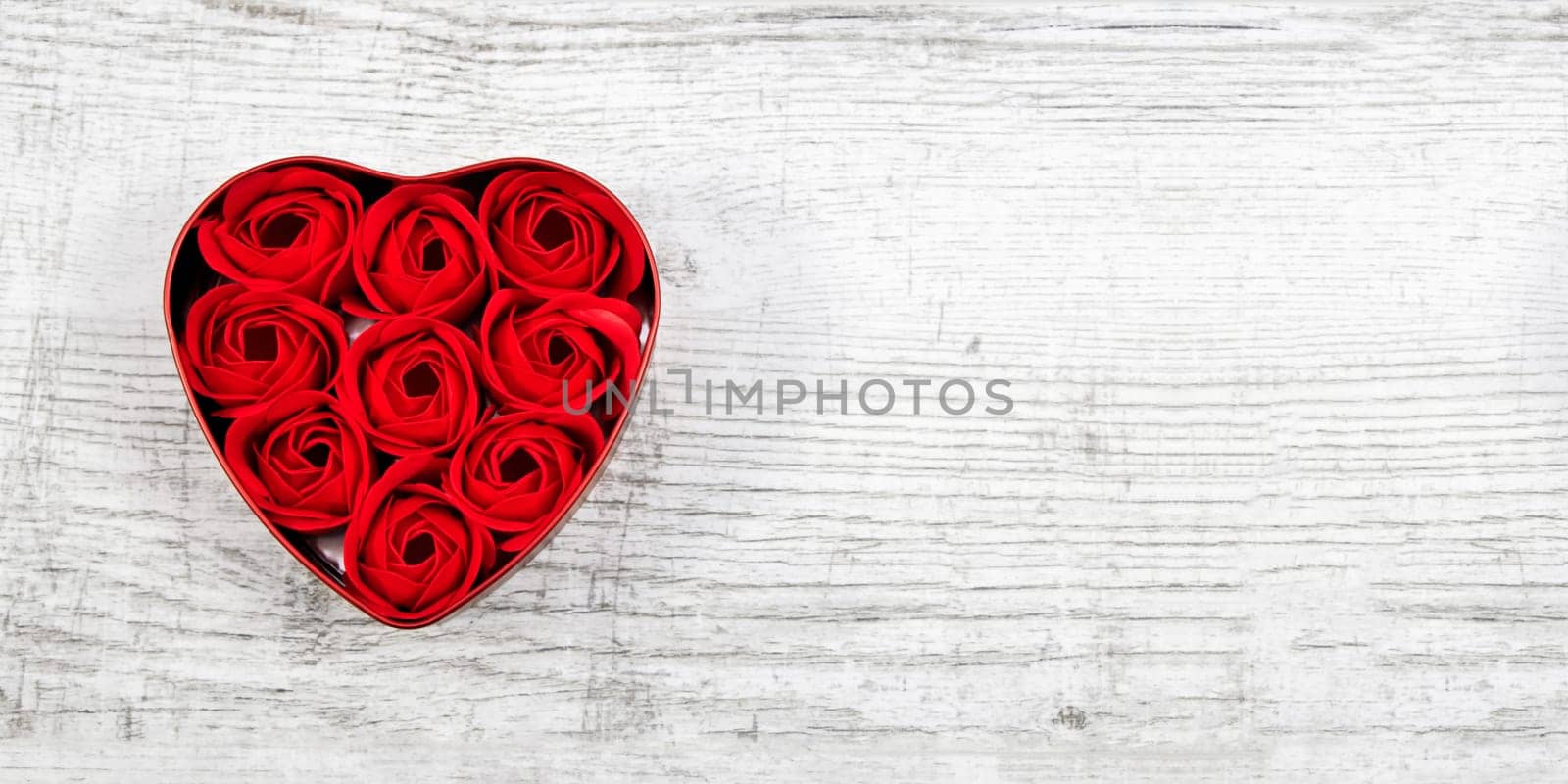 Red roses in a heart-shaped box