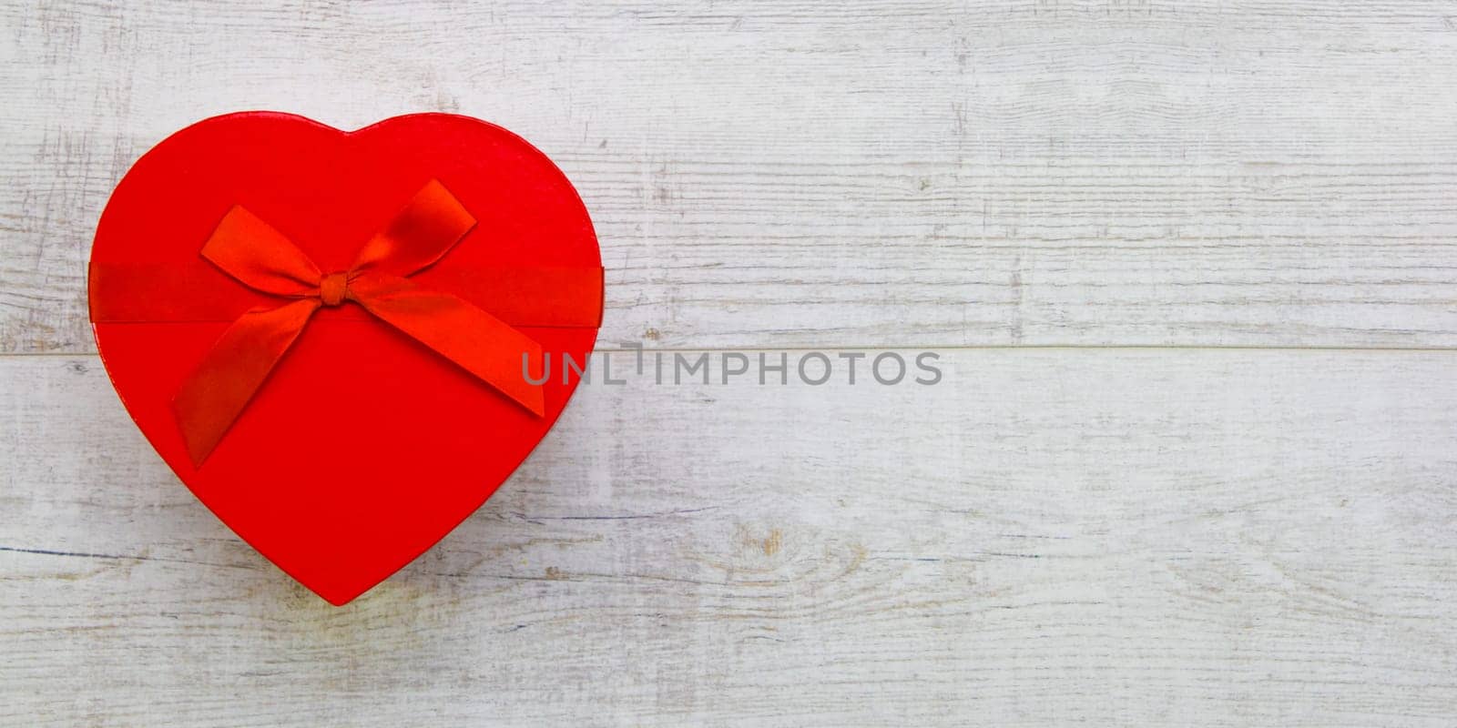 Red gift box with red ribbon and bow