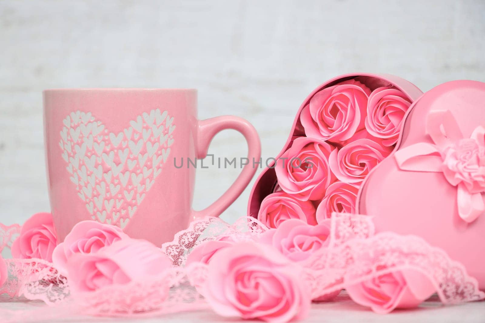 Pink porcelain coffee cup and pink heart roses