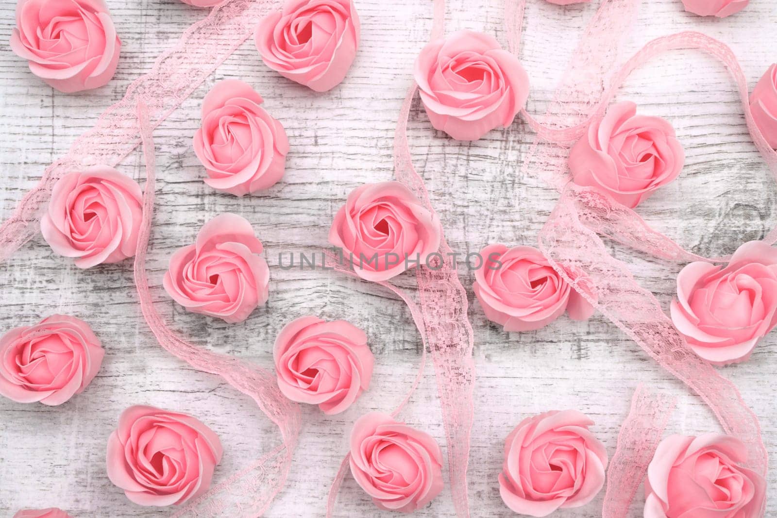Pink roses on the wooden background