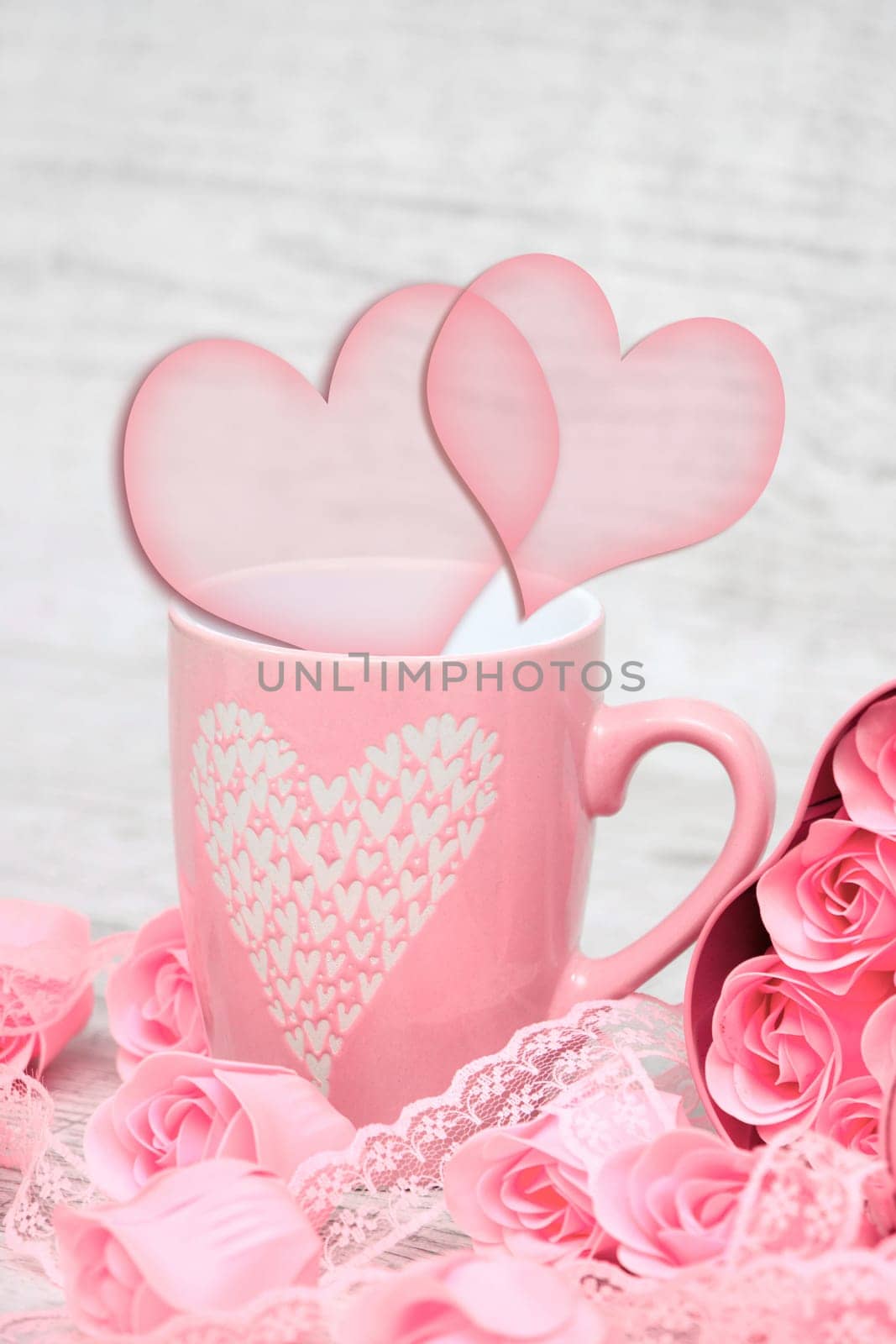 Pink porcelain coffee cup and pink heart roses