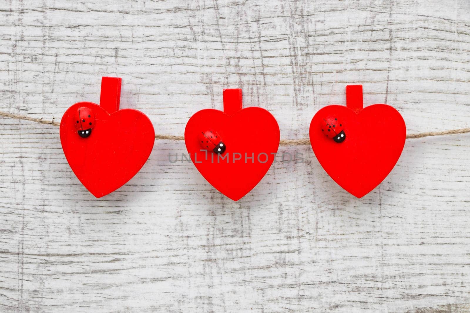 Red hanging hearts with ladybug