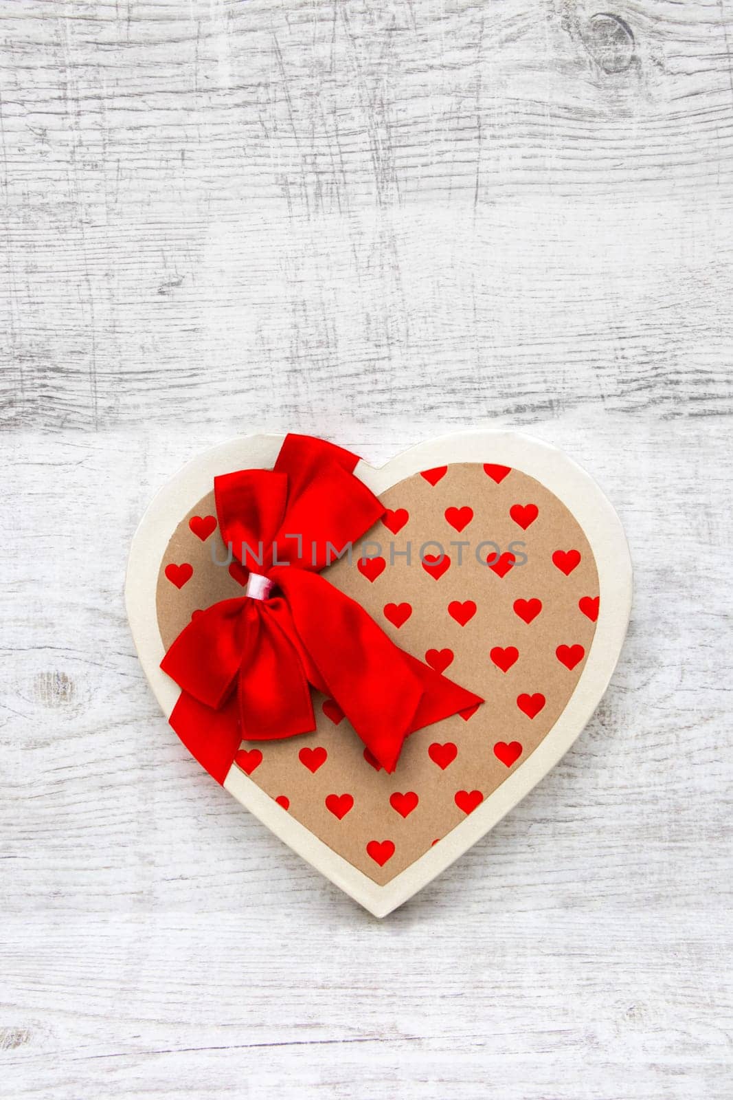 Heart-shaped box on a wooden background
