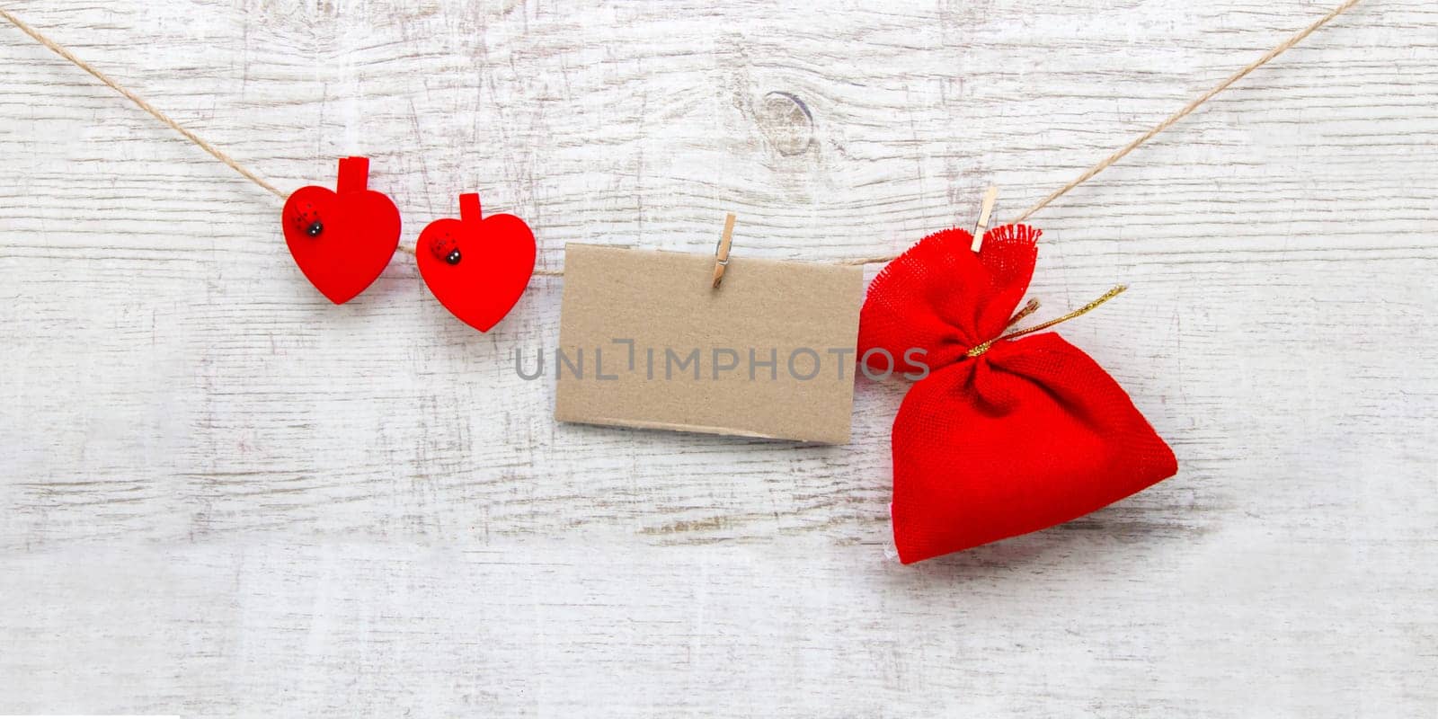 Gift sack with heart note in wooden background
