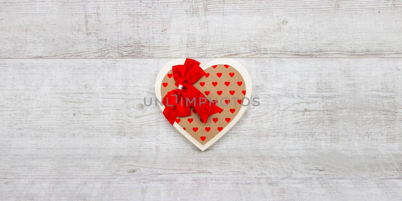 Heart-shaped box on a wooden background
