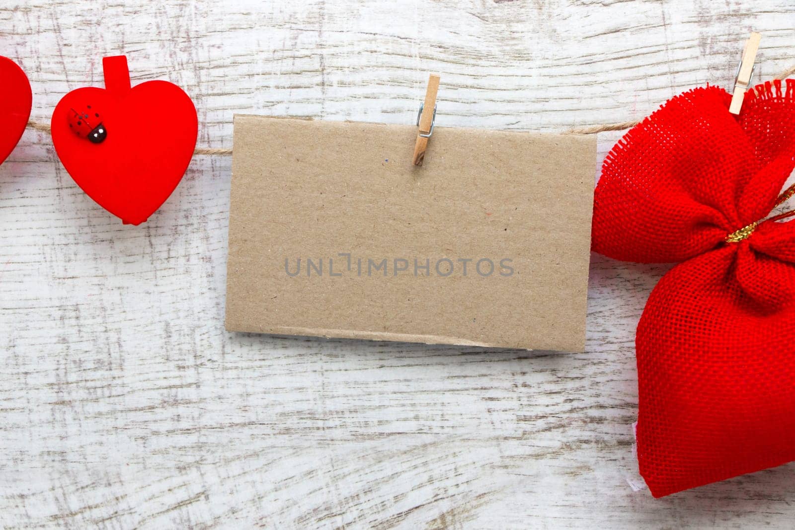Gift sack with heart note in wooden background