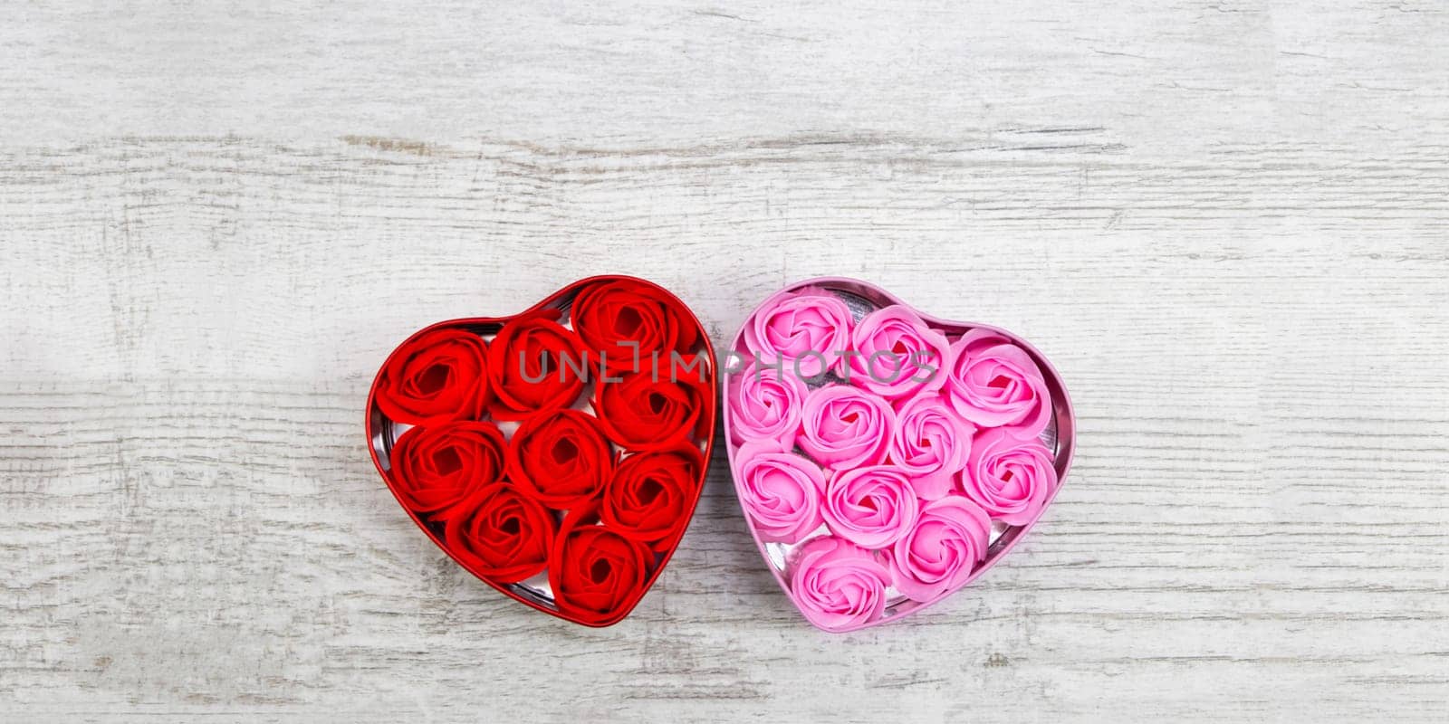 Pink and red roses on the wooden background