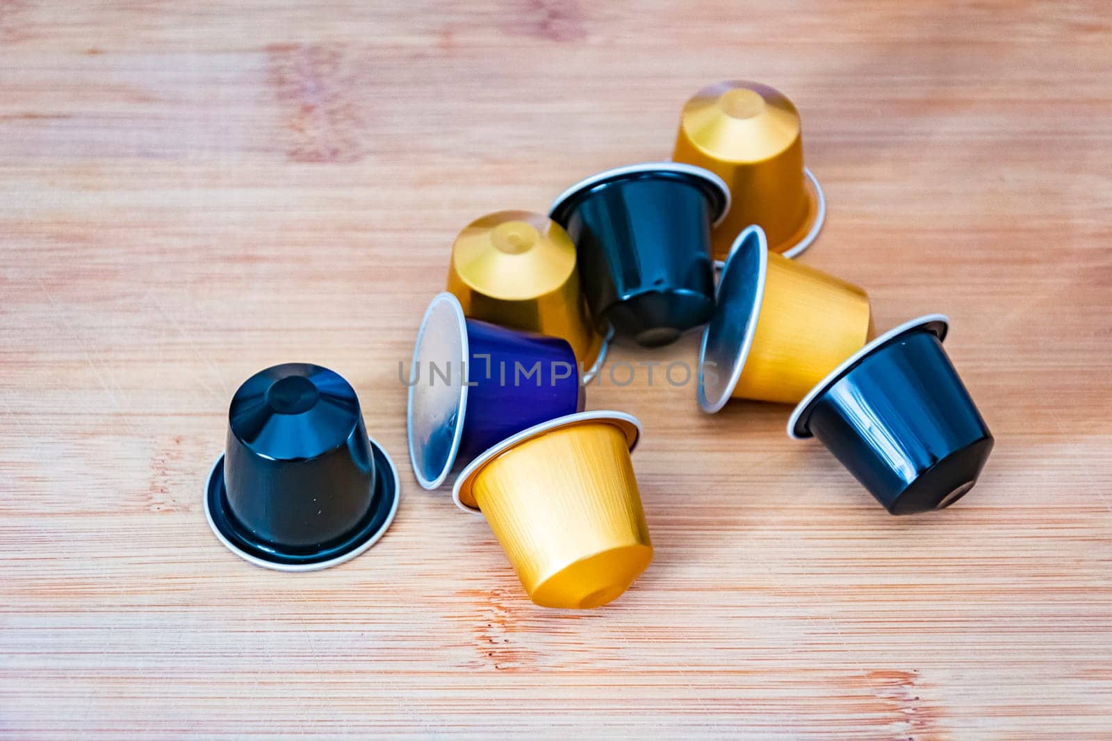 group of espresso coffee capsules with a wooden background