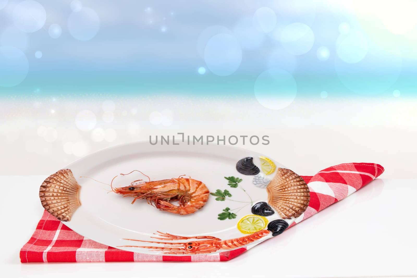 Table top on seafood background. A Fresh grilled big prawn tiger or shrimps on a white table in front of abstract blurred tropical beach with blue sky. Template for advertising.