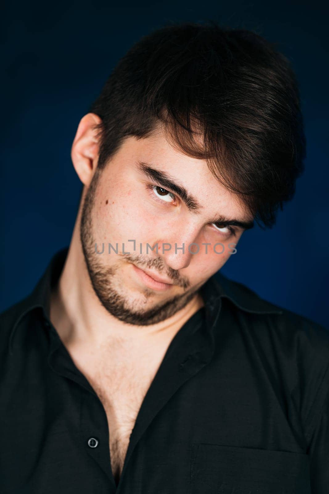 young brunette guy on a dark background.