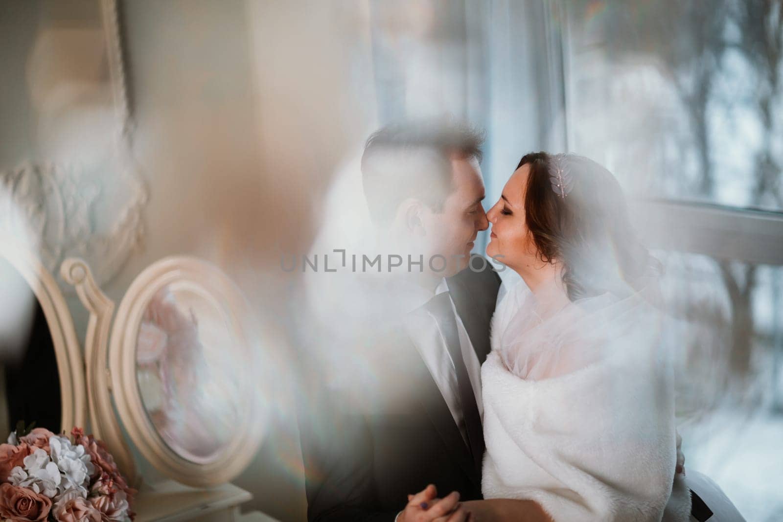 young bride and groom couple in a bright studio photo.