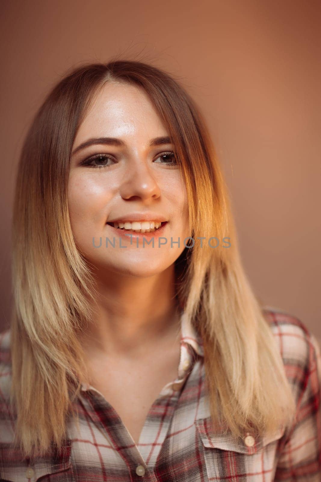 portrait smiling girl on orange background in studio.