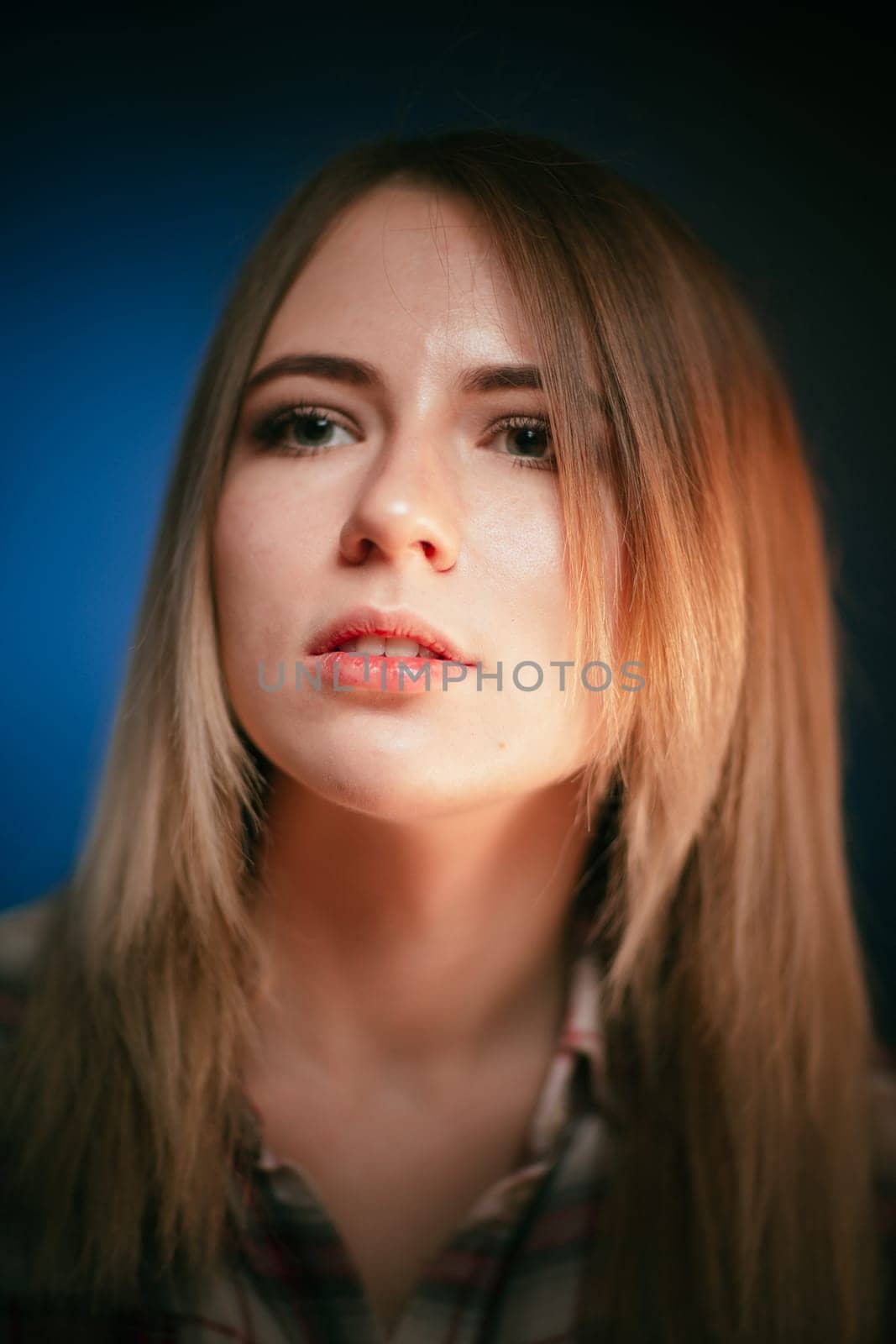 portrait smiling girl on blue background in studio.