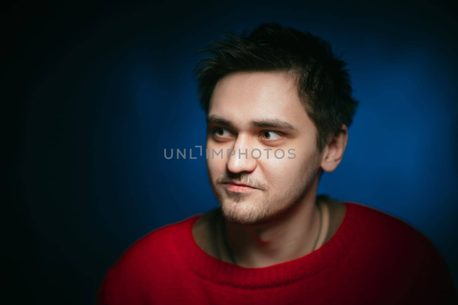 emotional young man photo in studio on blue background