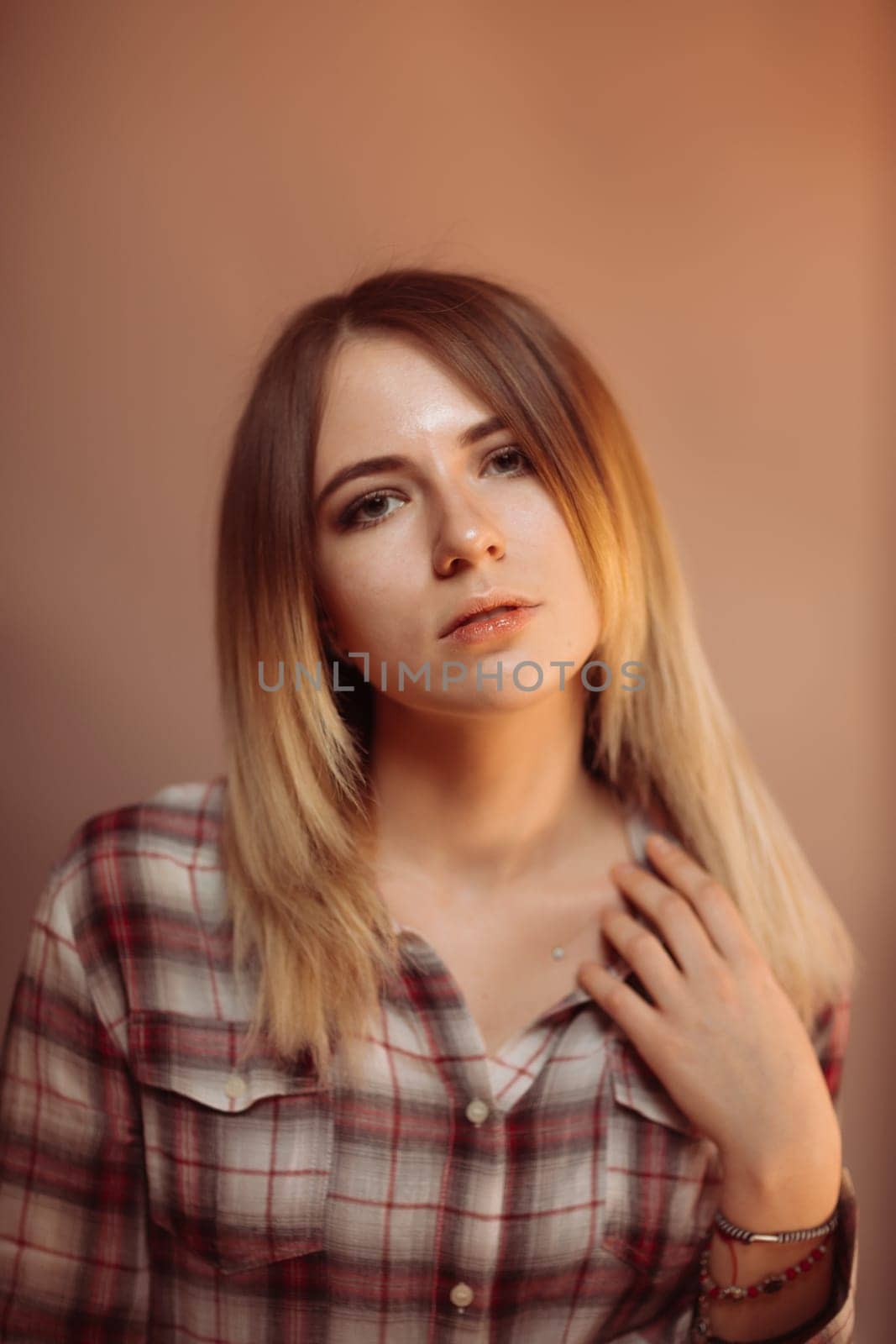 portrait smiling girl on orange background in studio.