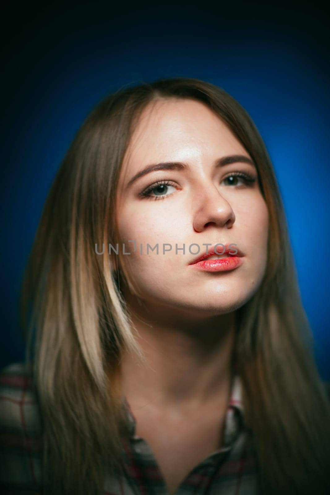 portrait smiling girl on blue background in studio.