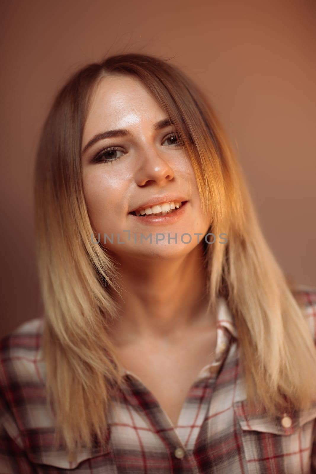 portrait smiling girl on orange background in studio.