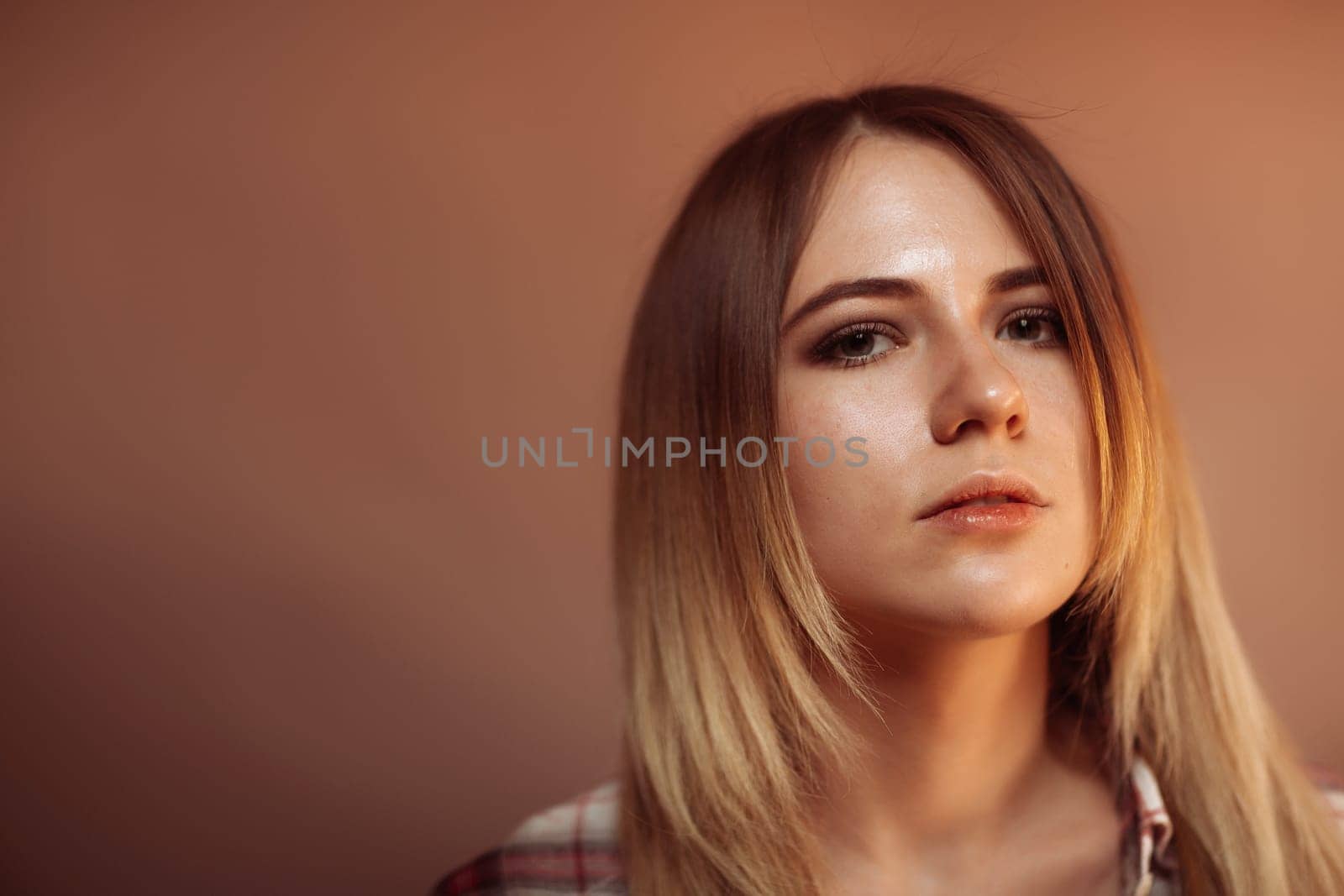 portrait smiling girl on orange background in studio.