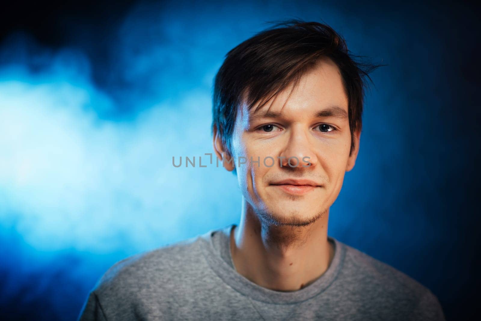 portrait emotional young man on blue background.