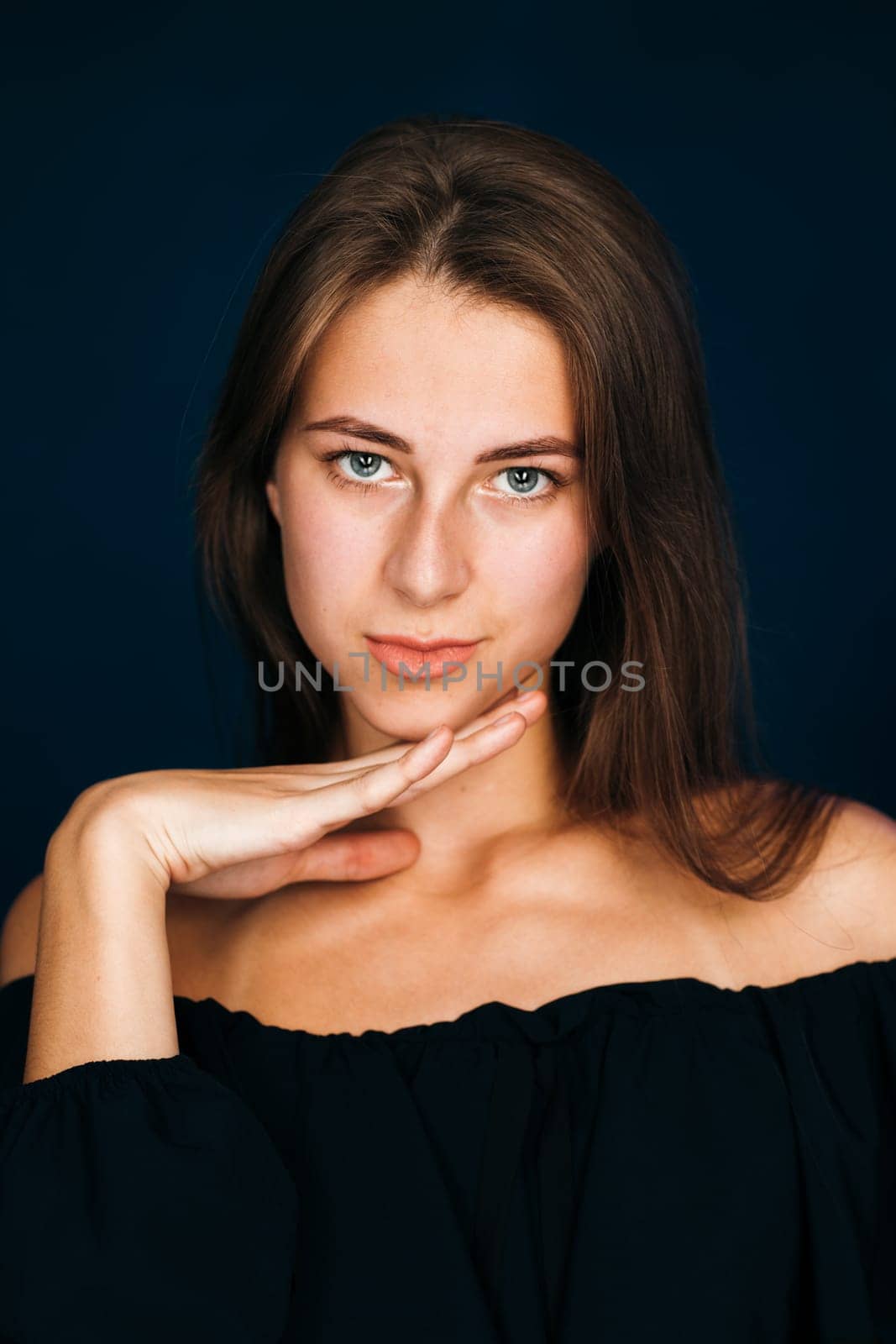 Portrait beautiful girl on a dark studio background.