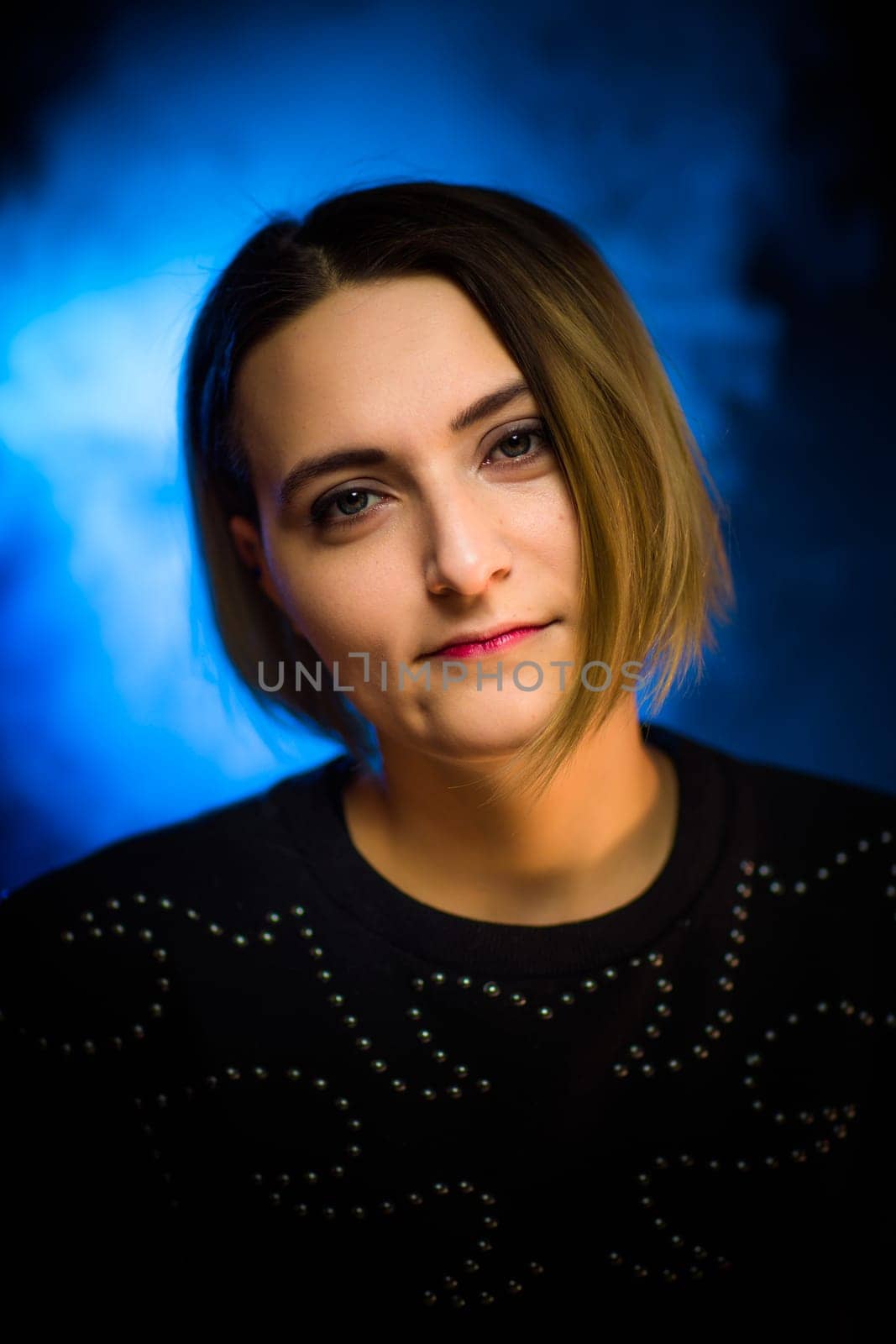 portrait emotional young girl on blue background.