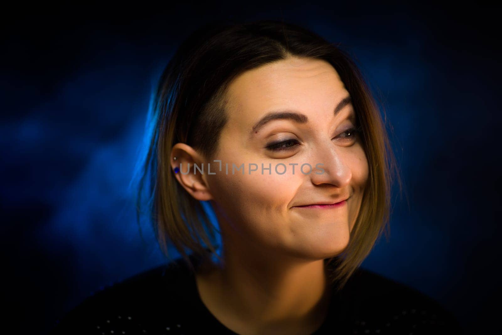 portrait emotional young girl on blue background.