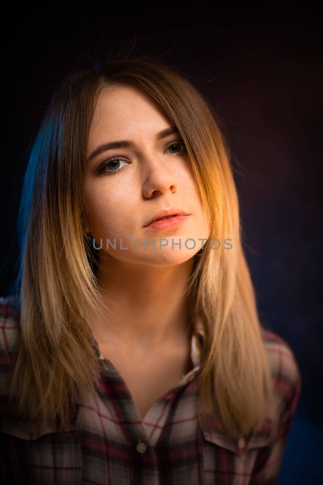 portrait smiling girl on blue background in studio.