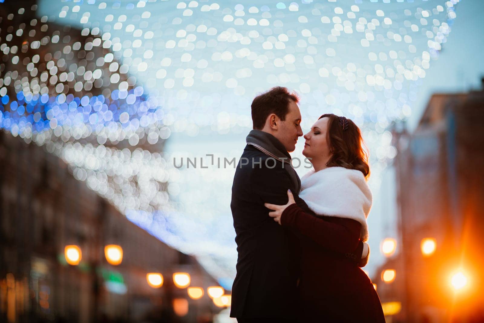 young couple on the background of the street in lanterns.