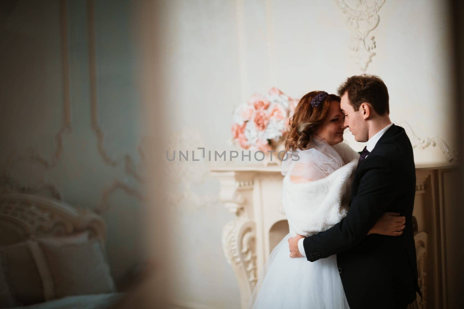 young bride and groom couple in a bright studio photo.