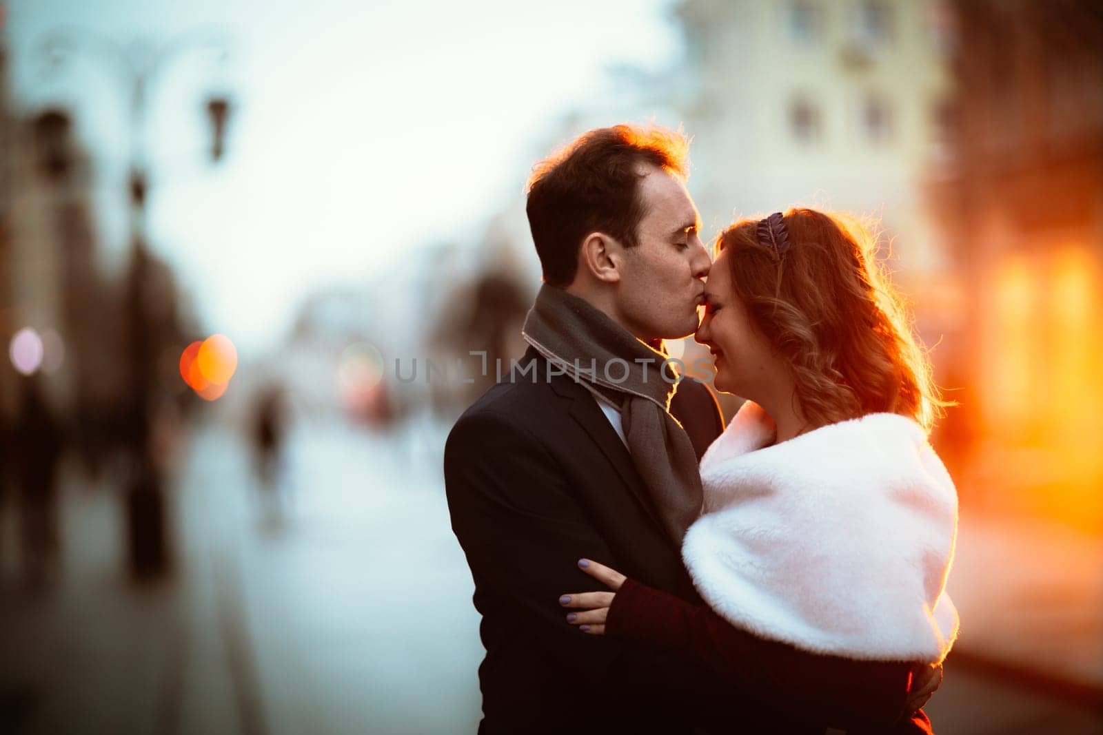 young couple on the background of the street in lanterns.