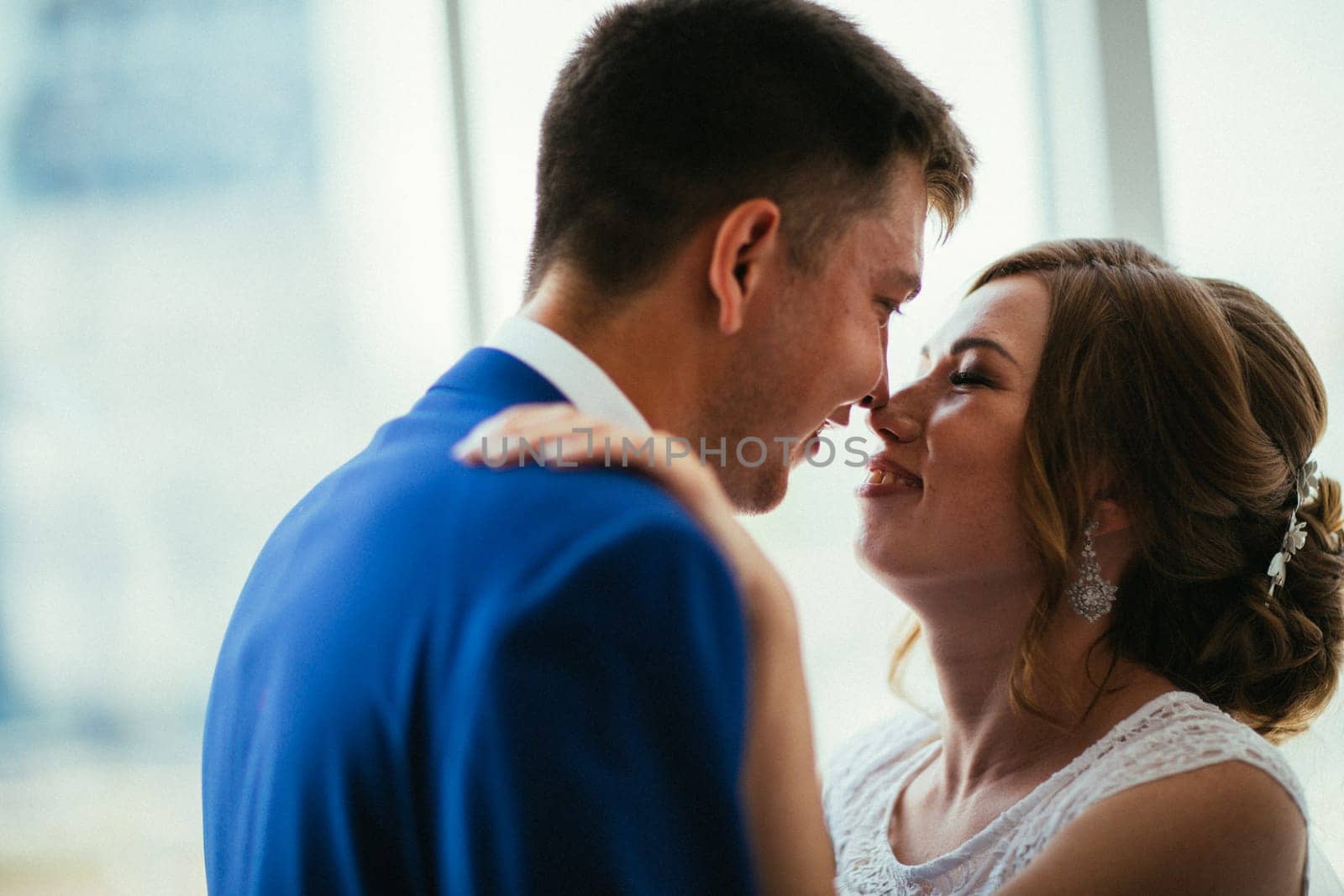 bride and groom on background clear windows.