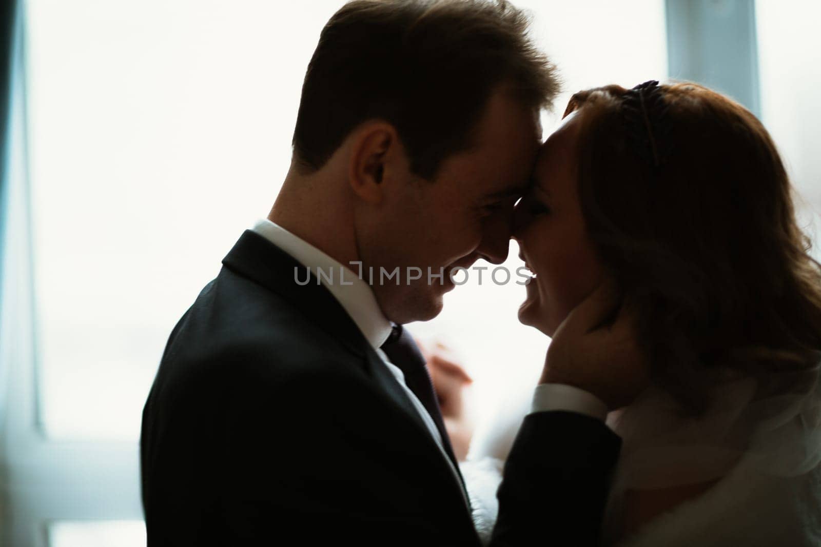 young bride and groom couple in a bright studio photo.