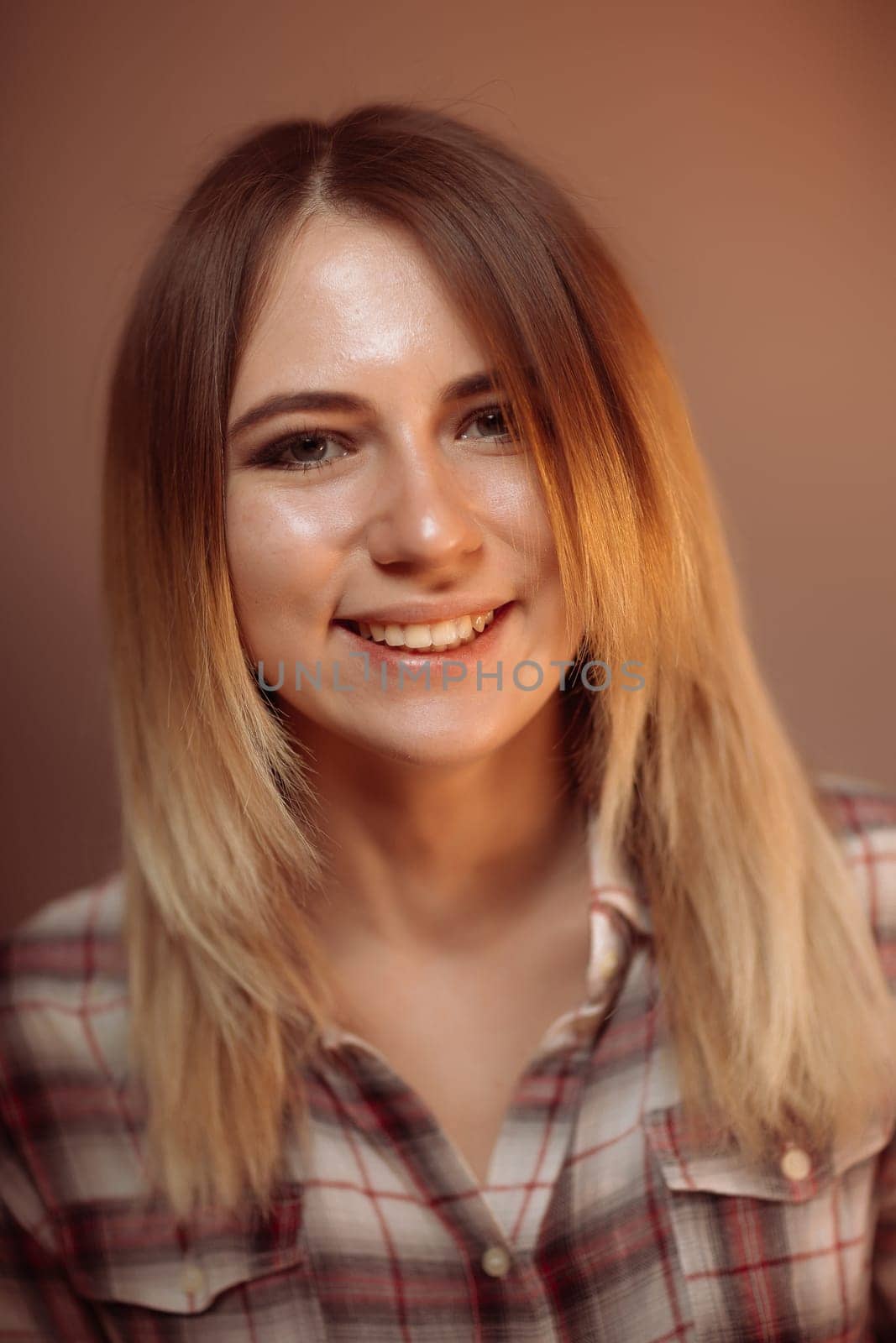 portrait smiling girl on orange background in studio.