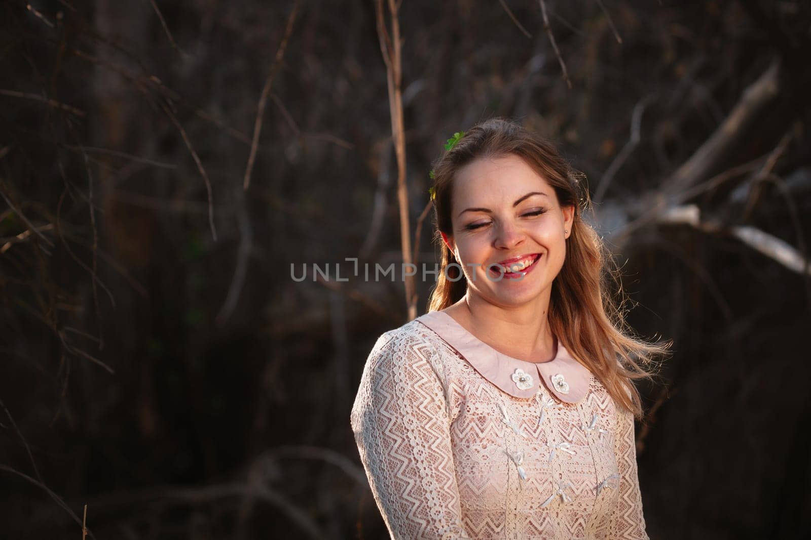 portrait of a girl in a field on a sunset background.