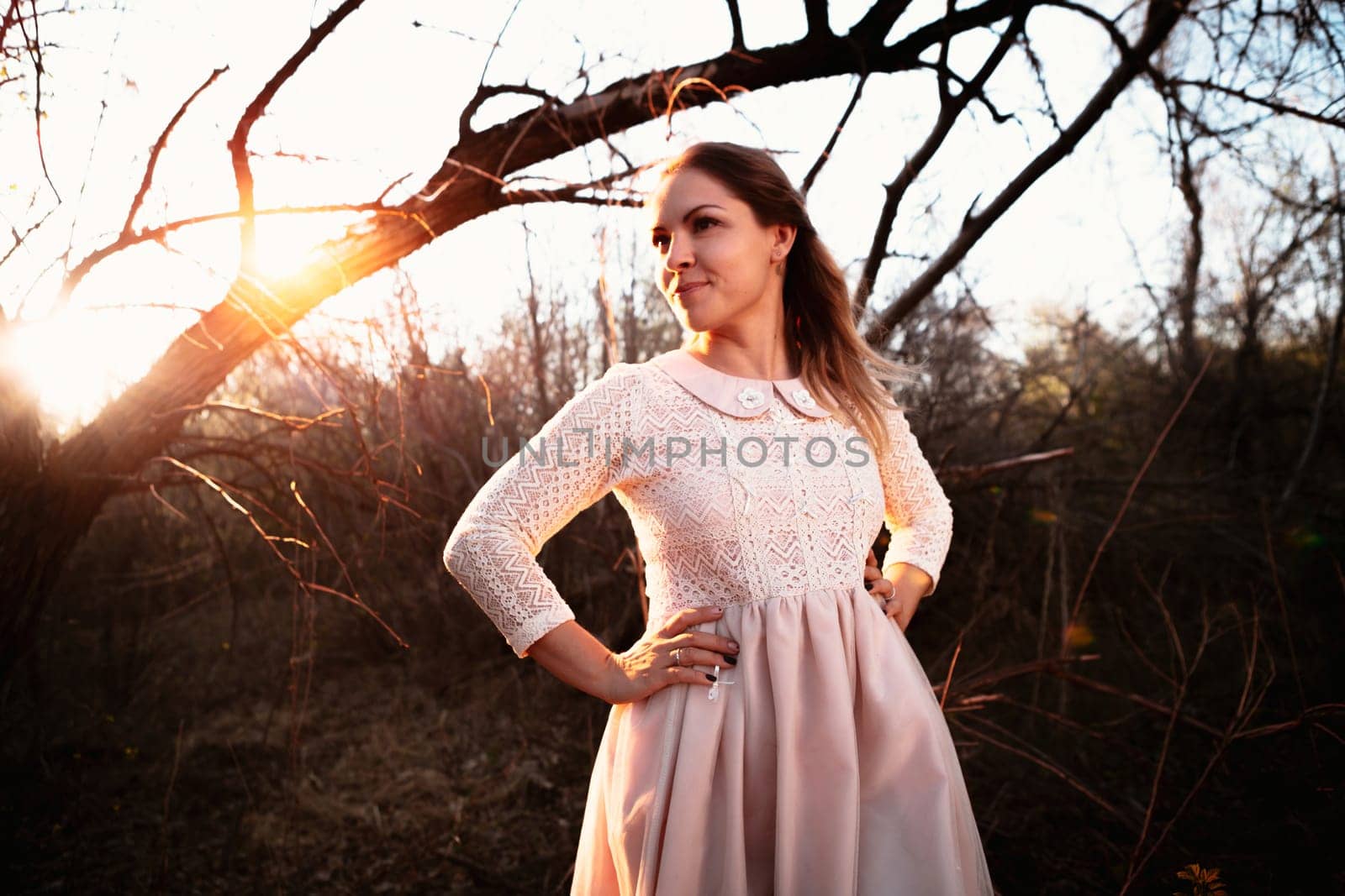 portrait of a girl in a field on a sunset background.