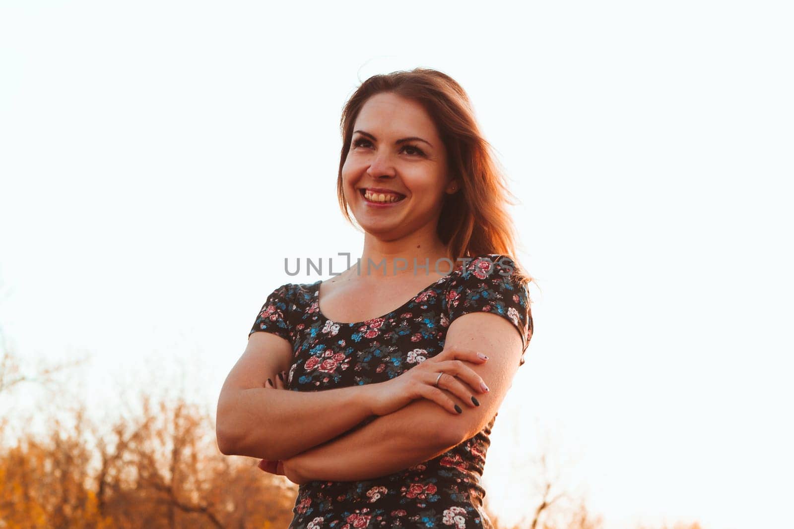 portrait of a beautiful girl in a field on a sunset background.