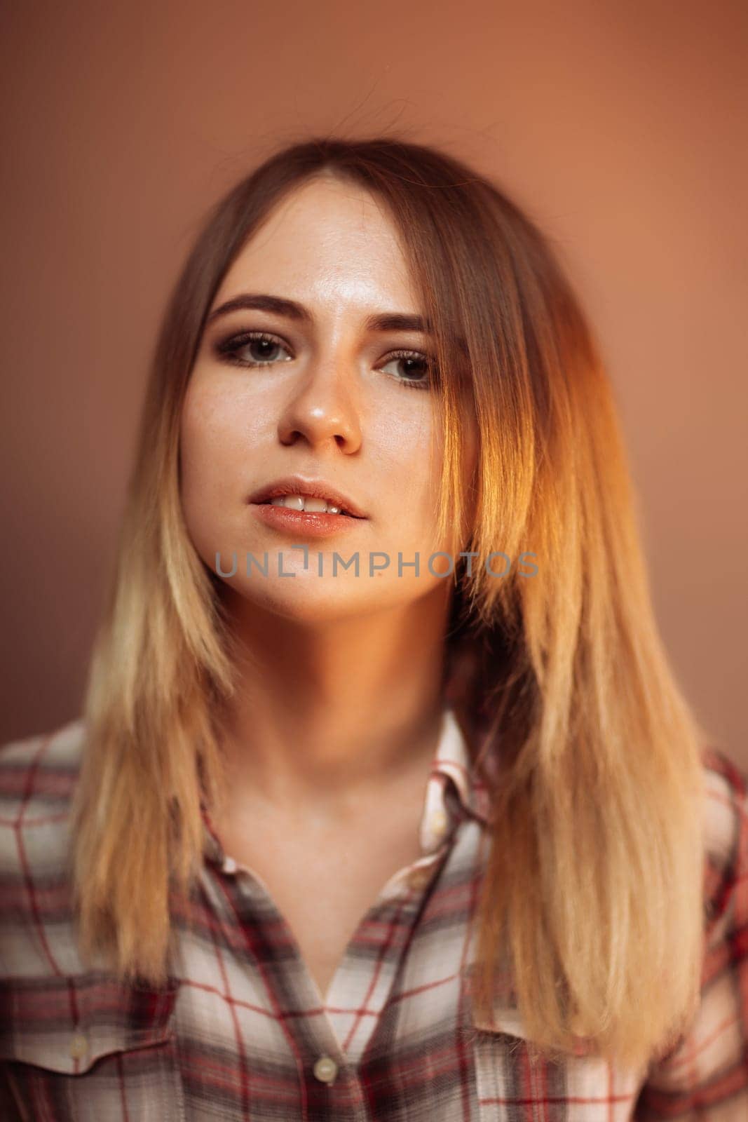 portrait smiling girl on orange background in studio.