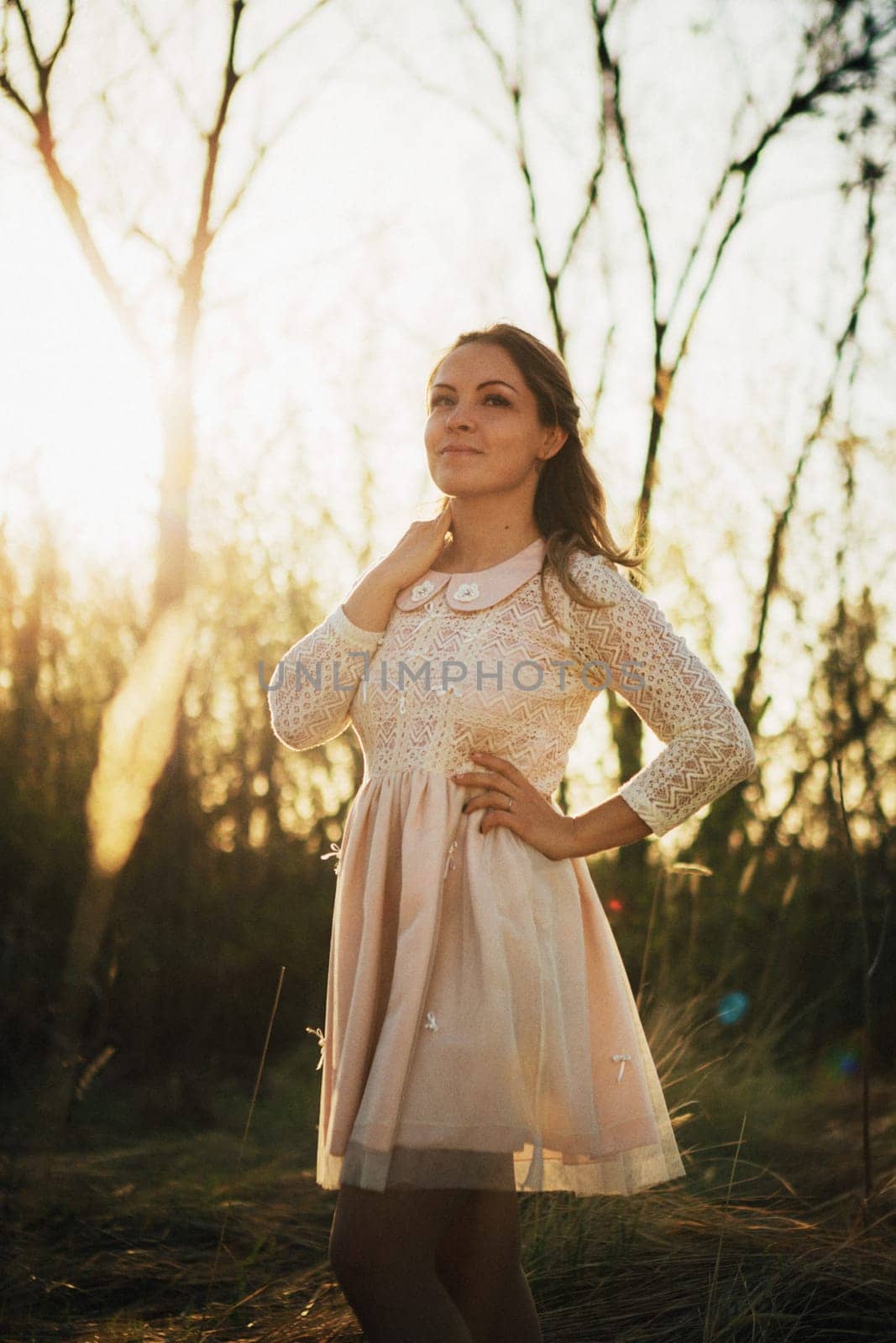 portrait of a girl in a field on a sunset background.