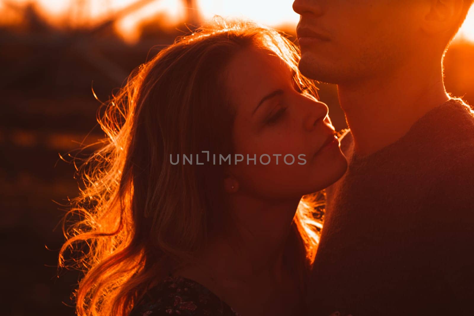guy and girl in the field on the sunset background.